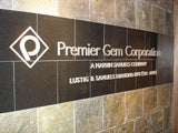 Custom cut out aluminum logo/letters mounted to customers granite wall